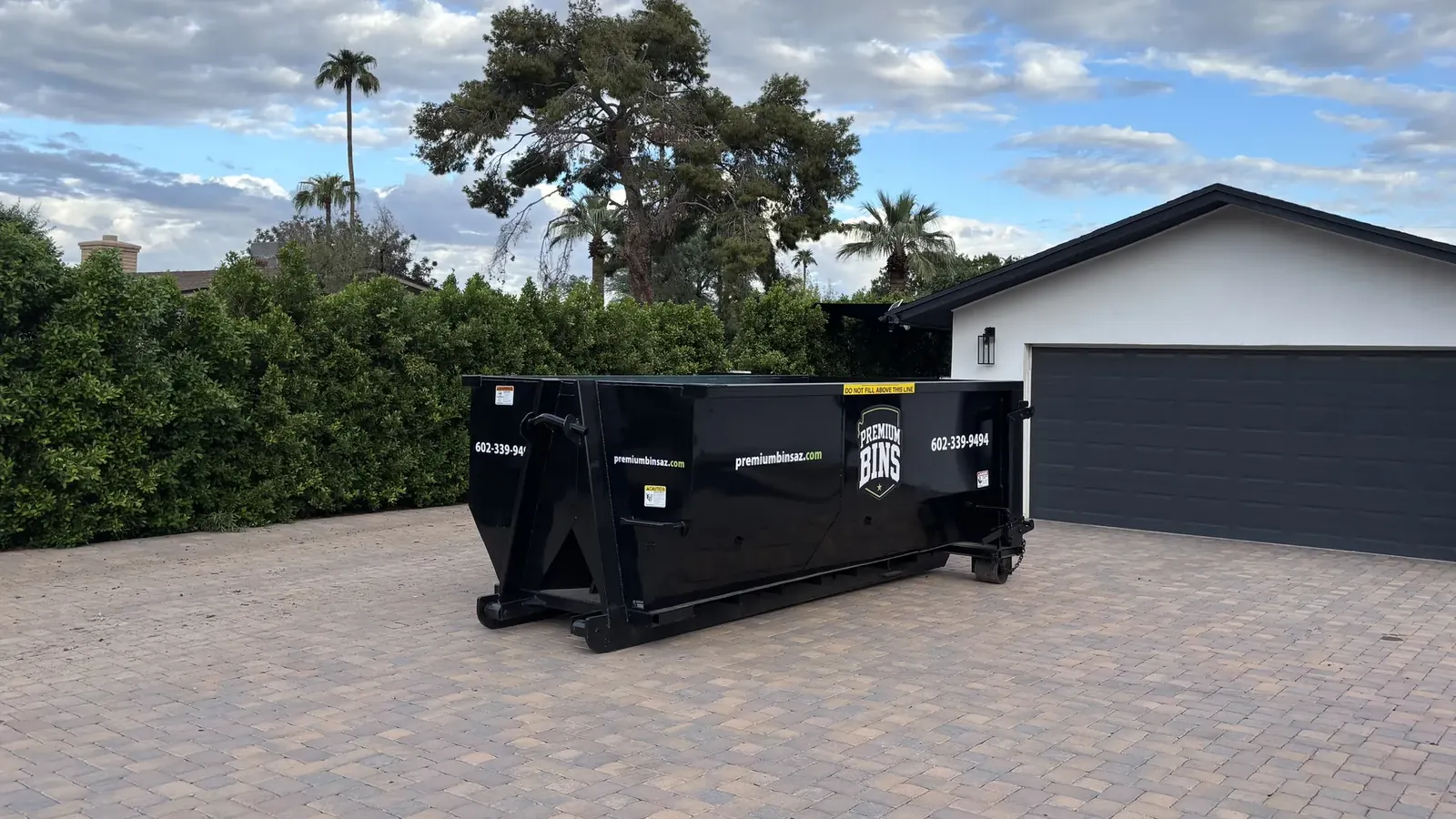 Premium Bins 15-yard dumpster on a paver driveway